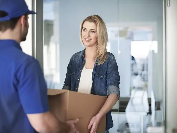 a delivery man delivering a package to a woman