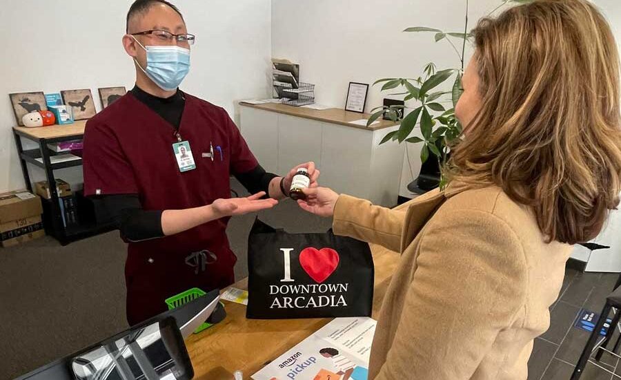 Dr. John Kong from Pacific Oak Compounding Pharmacy helping a customer