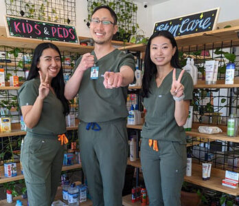 Dr. John Kong with two of his ladies staff.