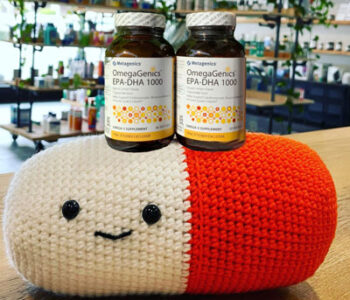 Pill pillow with prescription on top and blurred background of store.